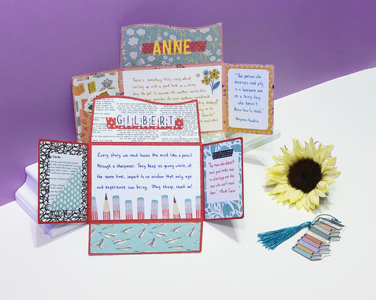 two opened cards, the paper has designs with pencils, flowers, and books